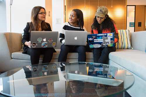 three woman with laptops explaining stuff
